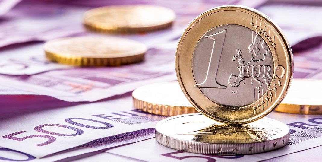 Several 500 euro banknotes and coins are adjacent. Symbolic phot